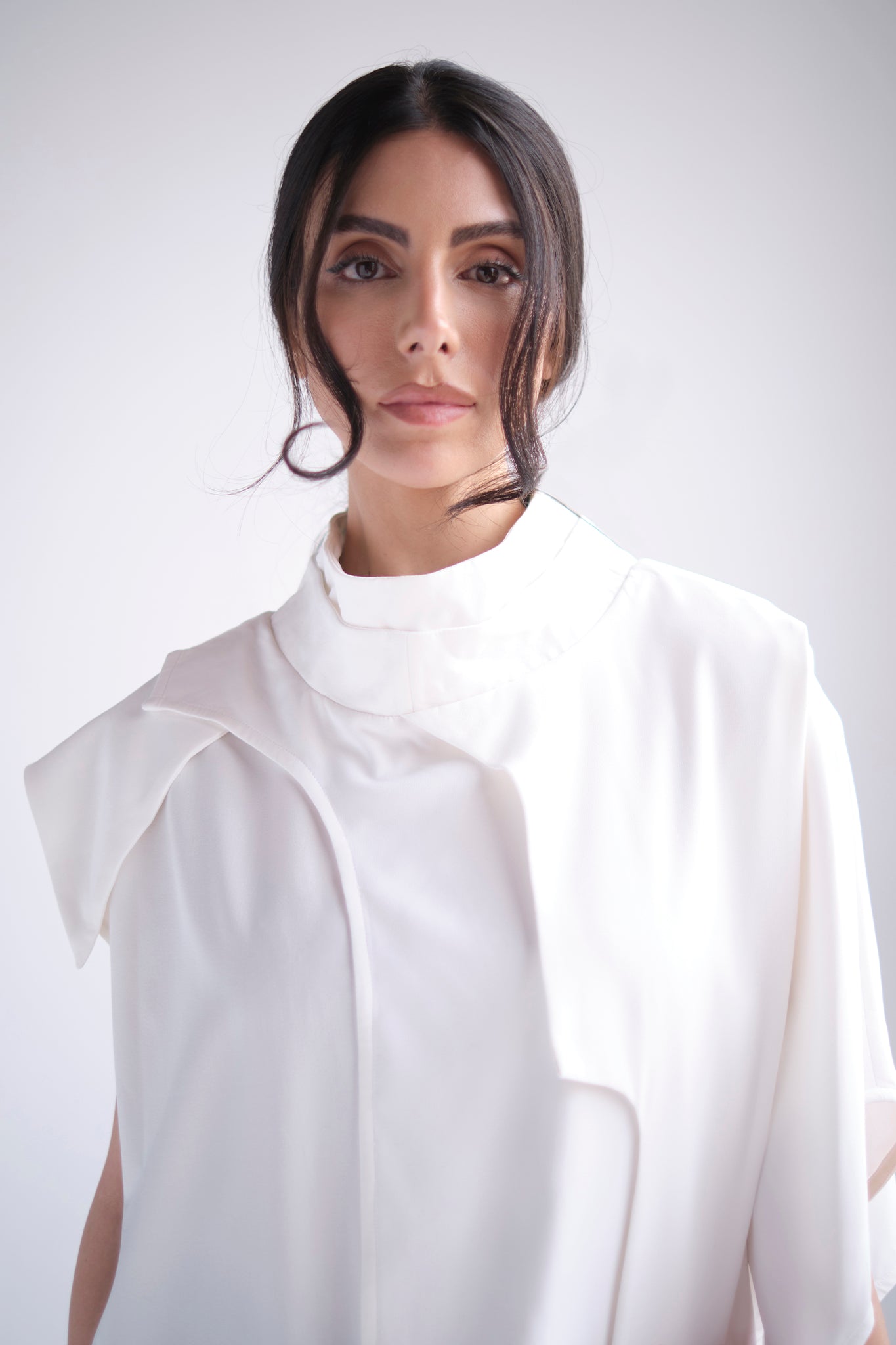 Asymmetrical layered tunic with high neck in white